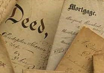 old, hand-written deed and mortgage papers