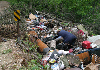 Household trash illegally dumped in a large ravine