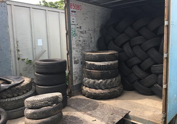 A box truck loaded with scrap tires