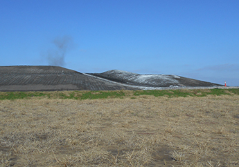 A view of the large landfill piles from a distance at the AECI New Madrid Utility Waste landfill