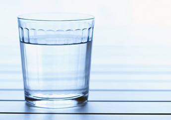 Glass of clear drinking water sitting on a countertop