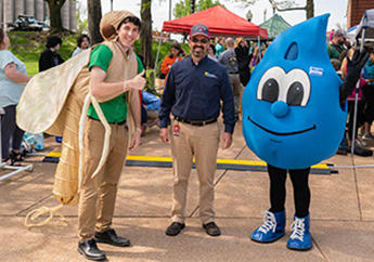 MoDNR Director Dru Buntin with the 2023 Earth Day mascots, MoDNR's "mayfly" and Missouri American Water's "Hydro"