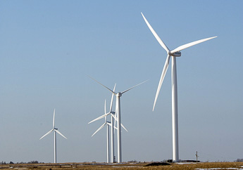 Several wind turbines rotating on the horizon