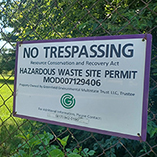 No trespassing signage on a chain-link fence surrounding the Greenfield Environmental Springfield Facility