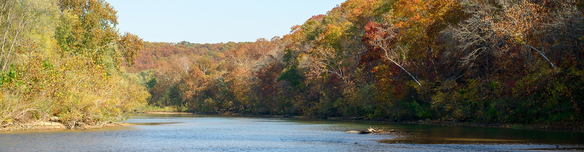 On the Missouri River with fall tree foliage in the background