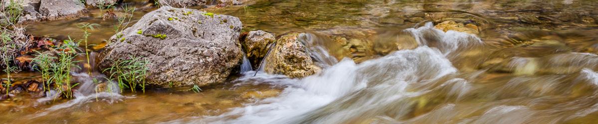 Water from Echo Bluffs creek rolling over large rocks