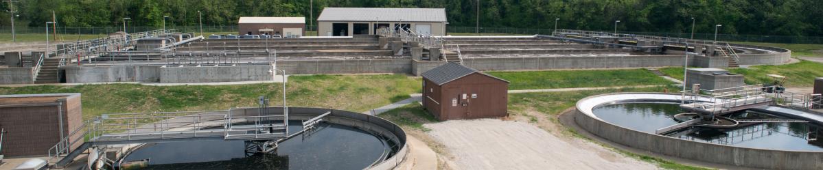 Aeration tanks, sedimentation tanks and chlorine tanks from an overhead walkway at a wastewater treatment facility 