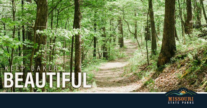 Trail through wooded area with Keep Baker Beautiful in white letters on bottom corner