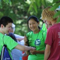 A team of students stand in a circle wearing their Missouri Envirothon t-shirts.