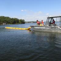 Environmental emergency response section practices boom deployment which is deployed on waterways to control petroleum spills.