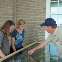 Environmental emergency response staff shows the Spillville display to visitors at the Missouri State Fair.