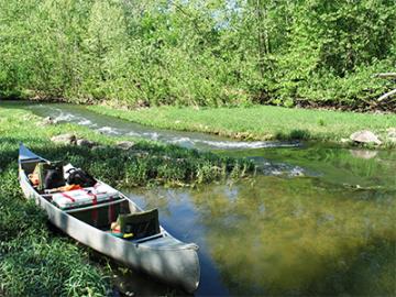 A loaded canoe on the shore of the Big River