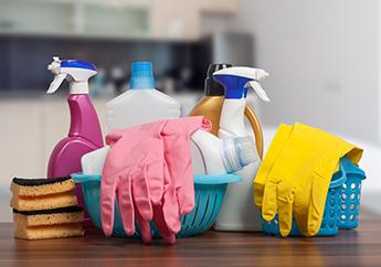 A plastic caddy filled with typical household cleaning supplies