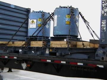Canisters of radioactive material being shipped on a flatbed trailer