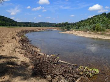 Stabilizing eroding stream banks and revegetating riparian buffers on property next to the Black River 