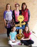 Five Rockwood School District students pose for a photo in front of a tan brick wall