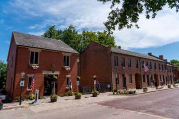 First State Capitol State Historic Site includes series of two-story red brick buildings.